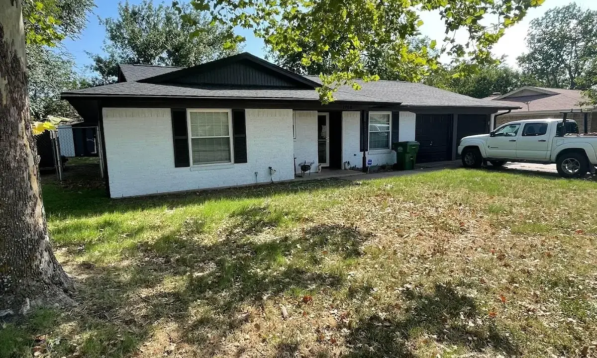 Professional roofing crew working on a residential roof in Granville